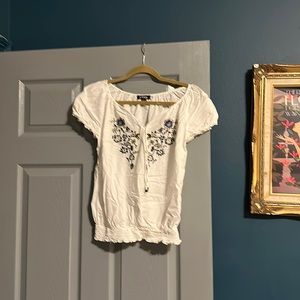 White peasant top with blue and yellow embroidery detail. Large. A Byer